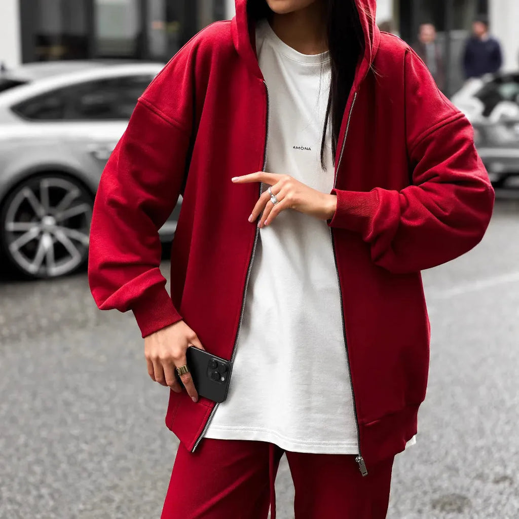 Red loose-fit street style two-piece set with long-sleeved coat and trousers on a model.