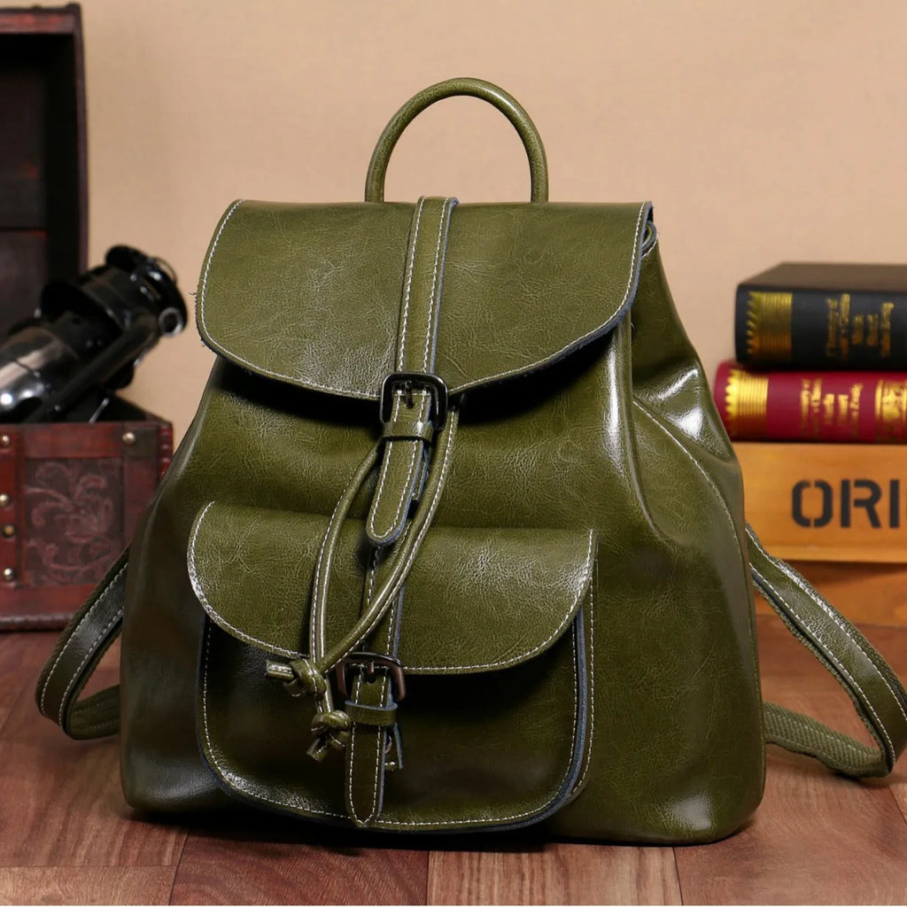 Korean style brown cowhide leather backpack with pull-belt fastening and front sandwich pocket.