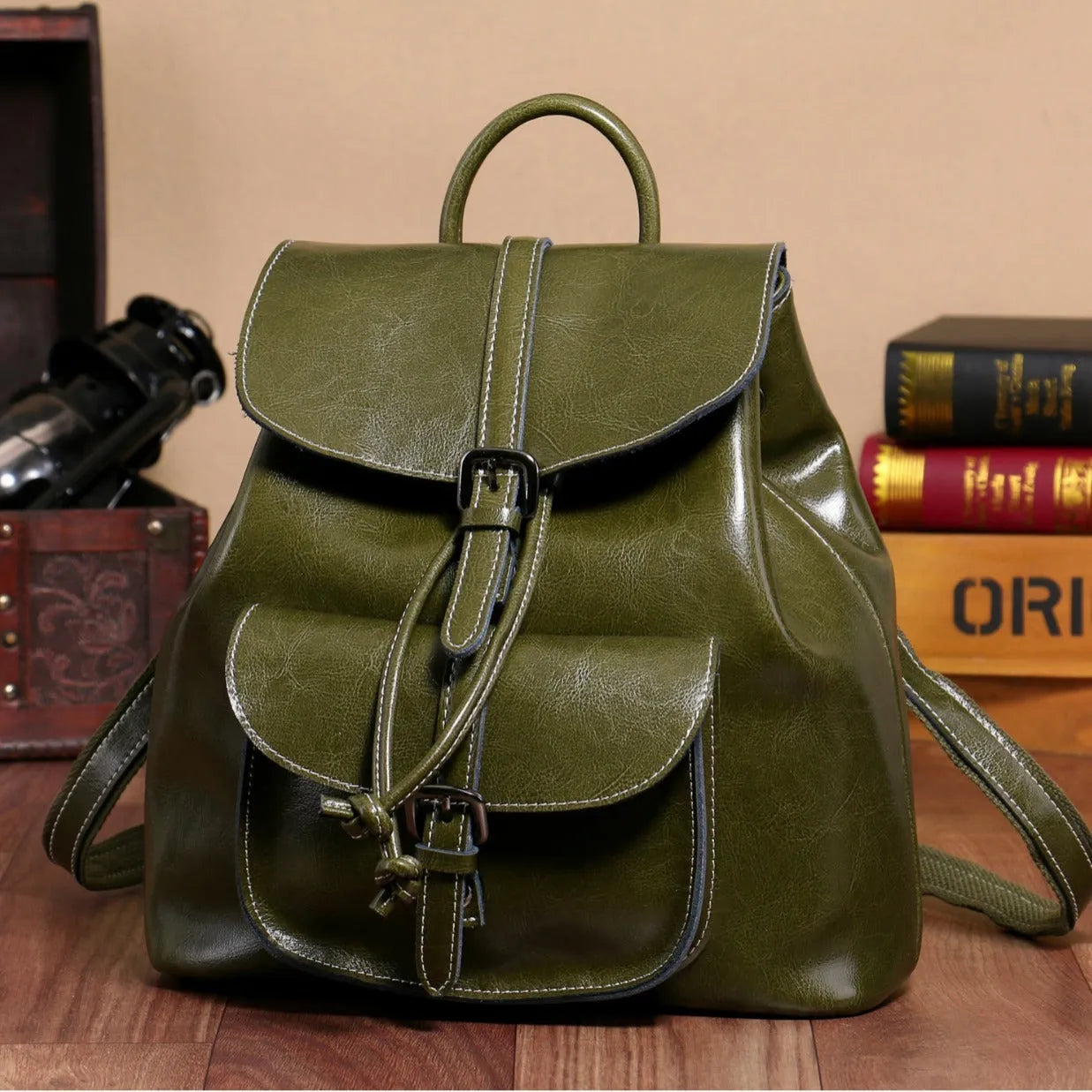 Korean style brown cowhide leather backpack with pull-belt fastening and front sandwich pocket.