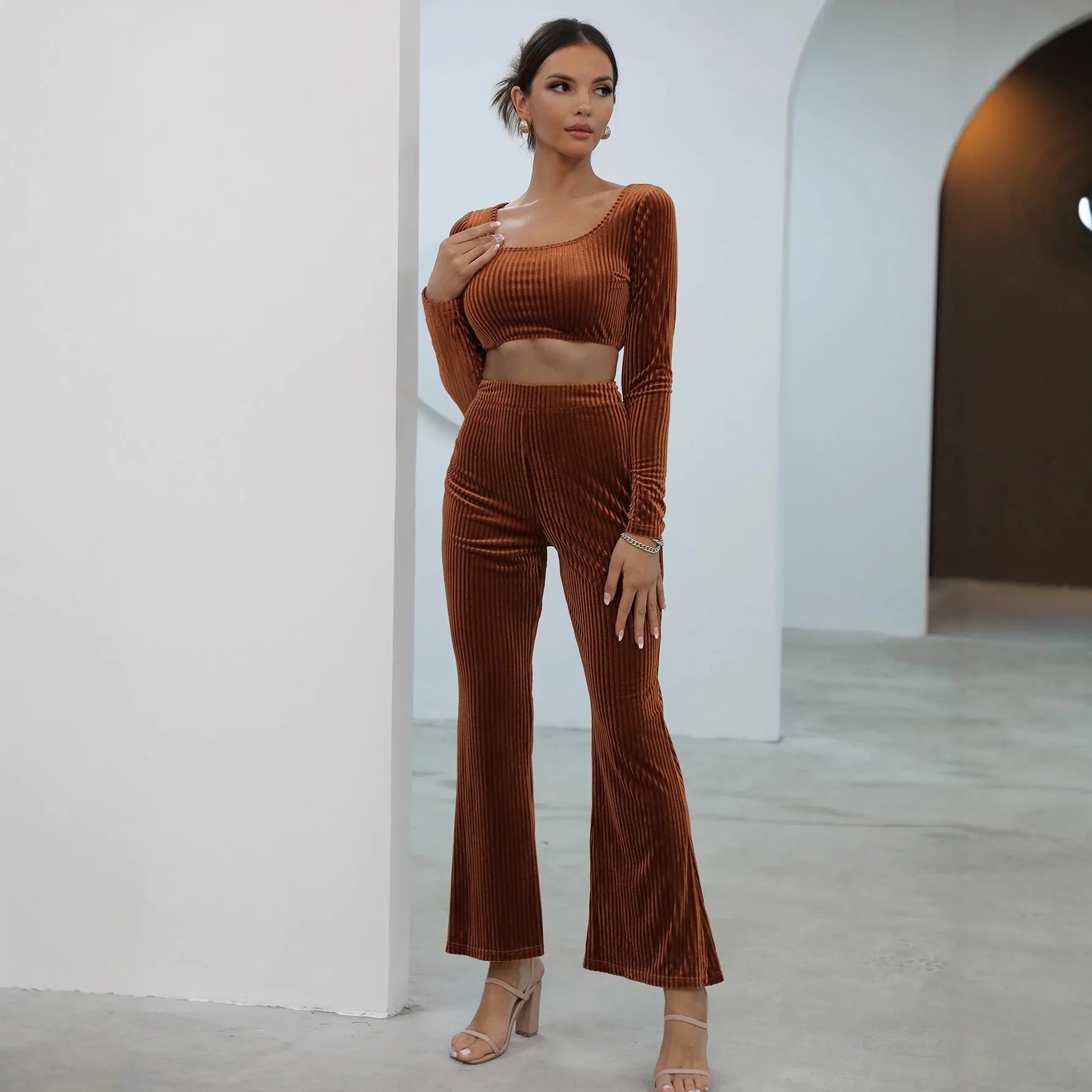 Caramel coloured long sleeve top and matching trousers laid flat, a casual two-piece sweater set.
