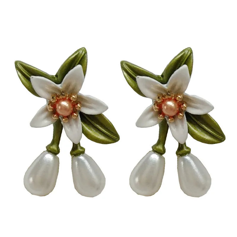 A pair of alloy flower earrings for women, showing sterling silver needle flower studs and a matching flower clip-on style.