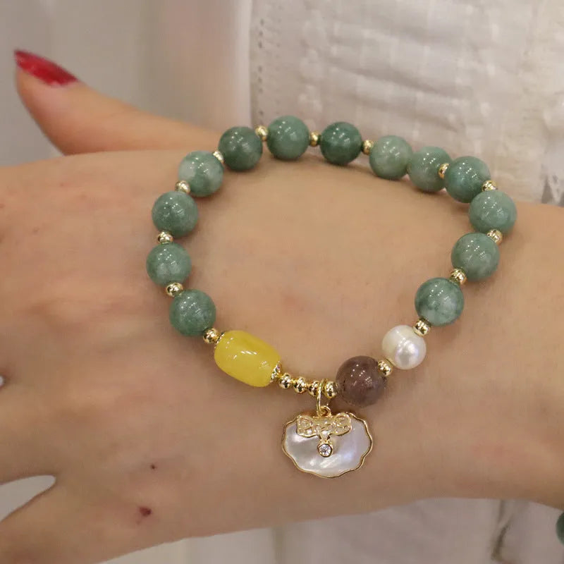 Women's green jade shell bead bracelet showing natural gemstone colour tones