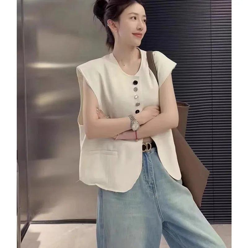 Women's loose fit sleeveless vest in beige and black, showing V-neck and pocket detail.