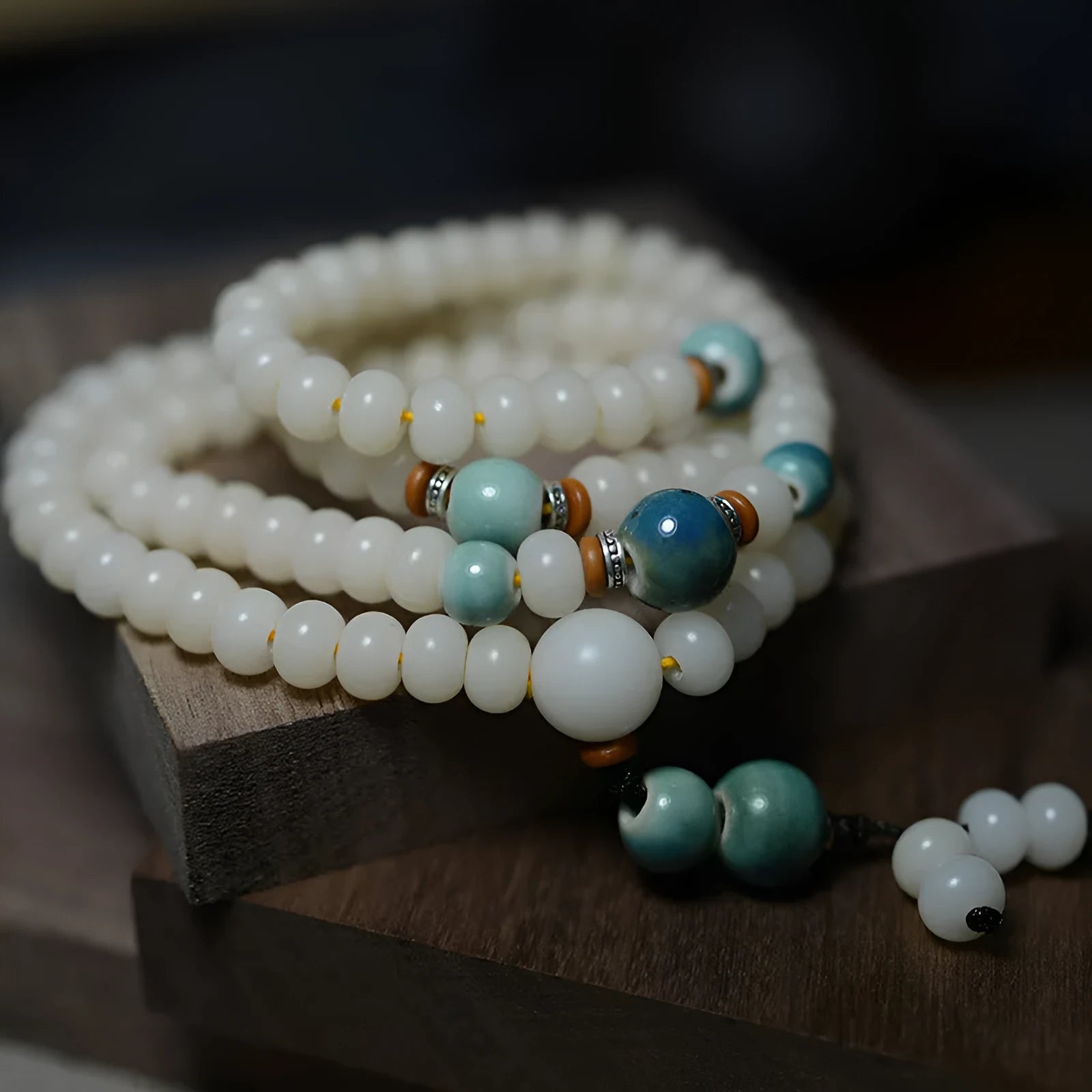 White jade bodhi root oblate bead bracelet with 108 flat round beads in 7x9mm and 8x10mm sizes.
