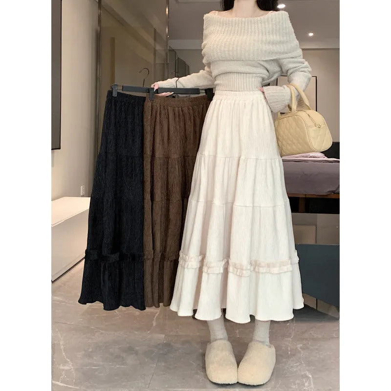 Corduroy A-line midi skirt with elastic waistband in milky white, shown on a hanger.
