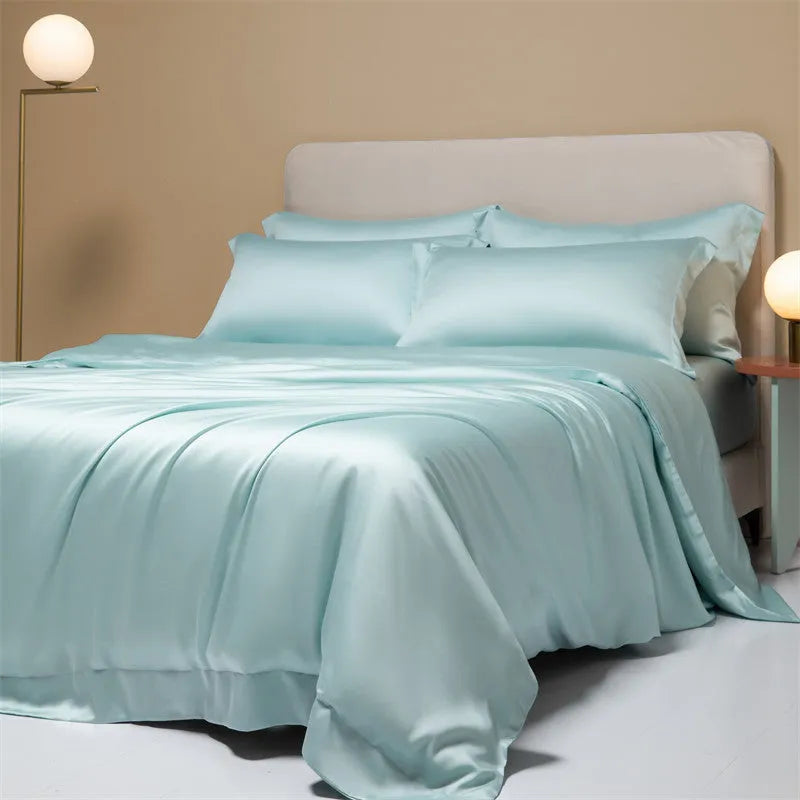 A modern, neatly made bed with a Lenzing Tencel duvet cover and pillowcases in a choice of nine colours like Sea Salt Blue.