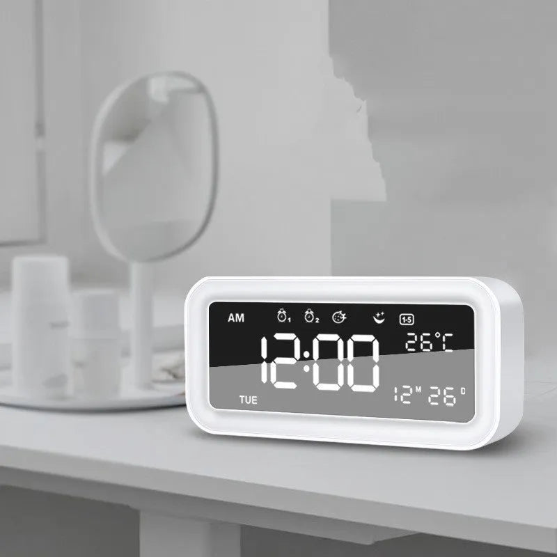 Rectangular blue and pink multifunctional LED atmosphere alarm clock with digital display and quartz glass mirror.