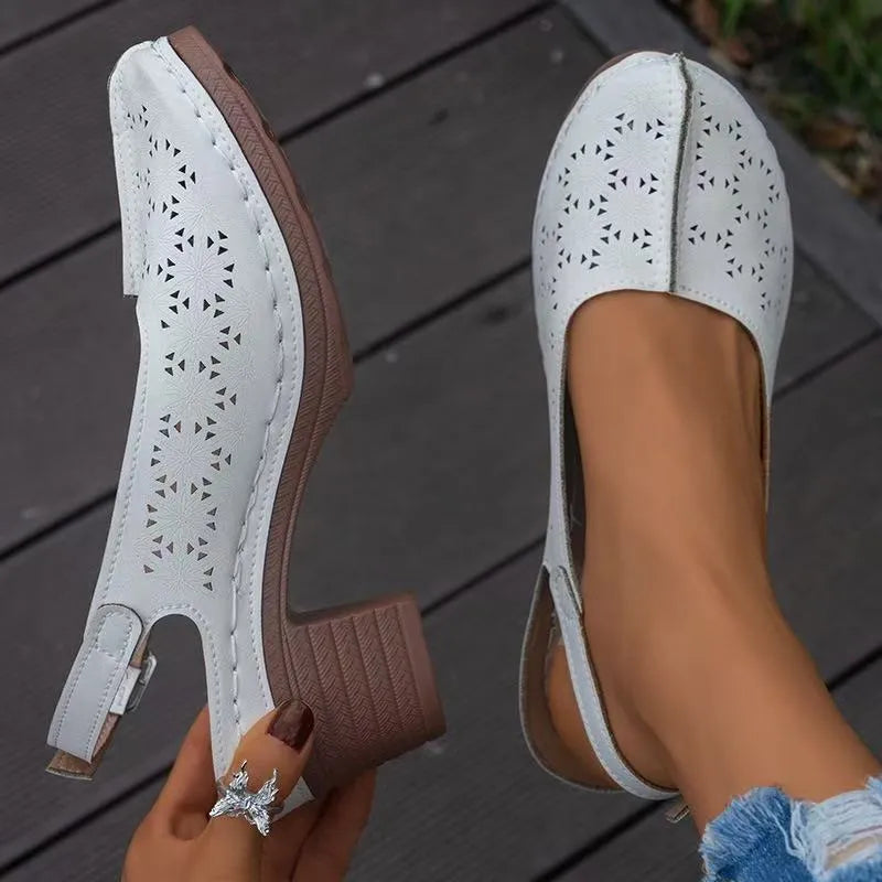 Women's black closed toe wedge sandals with a round toe and rubber sole, shown from the side.