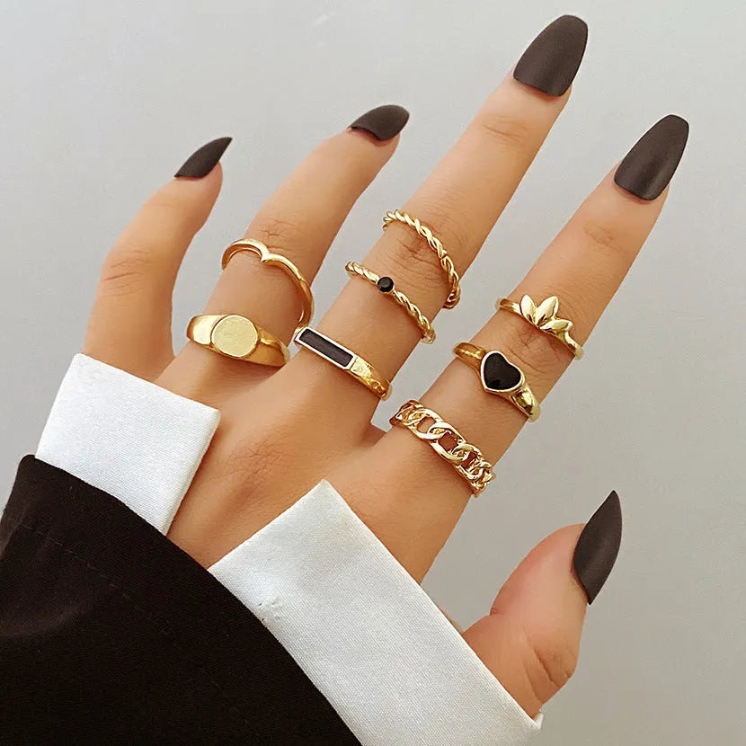 Alloy ring set with butterfly and snake retro geometric designs on display