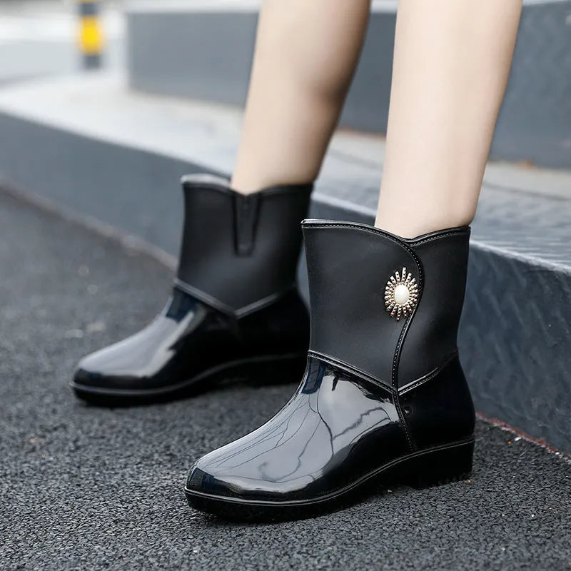 Women's purple PVC rain boots with non-slip sole and middle tube height