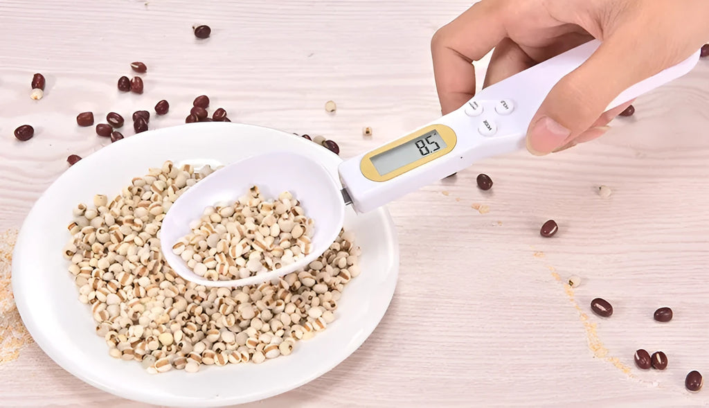 Black electronic measuring spoon scale with digital display showing weight measurement