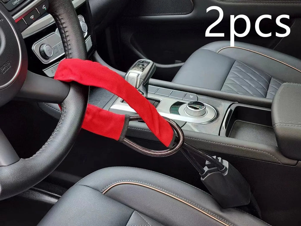 Red iron car steering wheel lock for General Motors vehicles on a steering wheel.
