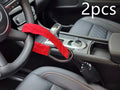 Red iron car steering wheel lock for General Motors vehicles on a steering wheel.