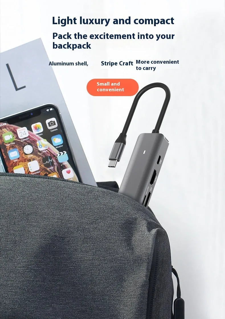 LQT-LH07 7-in-1 card reader and USB-C PD computer hub on a desk next to a laptop.
