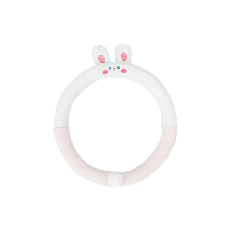Plush furry steering wheel cover with embroidered panda face, fitted on a car steering wheel.