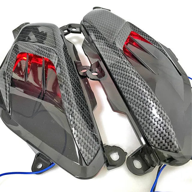 Pair of black LED side lamps for Yamaha NMAX scooter with carbon fibre decoration and clear lens.