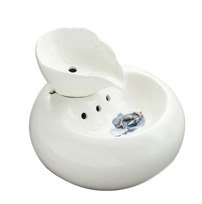 White porcelain leaf-shaped automatic cat water dispenser on floor