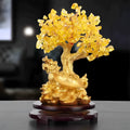 A citrine-coloured resin decorative ornament of a small water turtle and a money tree in Chinese style.