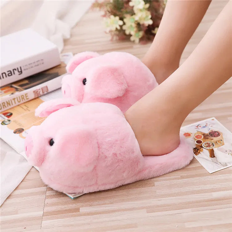 Pink pig character plush floor slippers on a white background