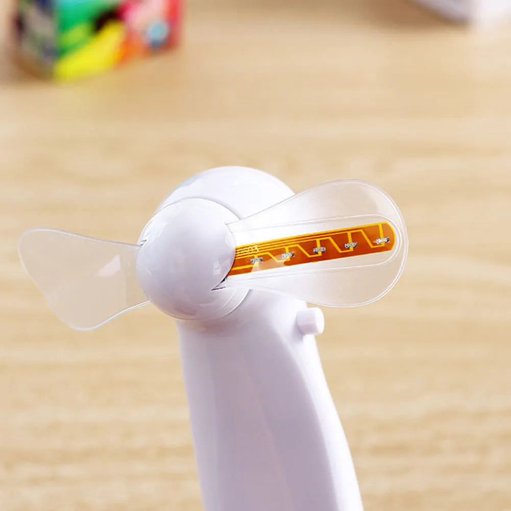White handheld mini fan with flashing blue and red LED 'I Love You' pattern on display.