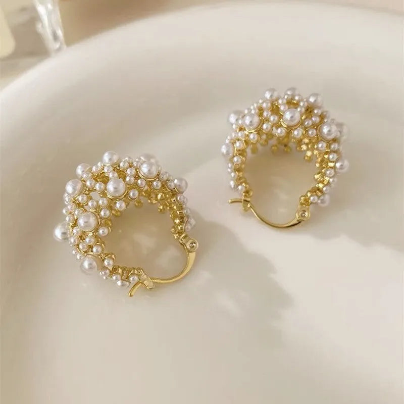 Gold tone women's flower basket earrings with small rice-shaped beads and pearl inlay detail