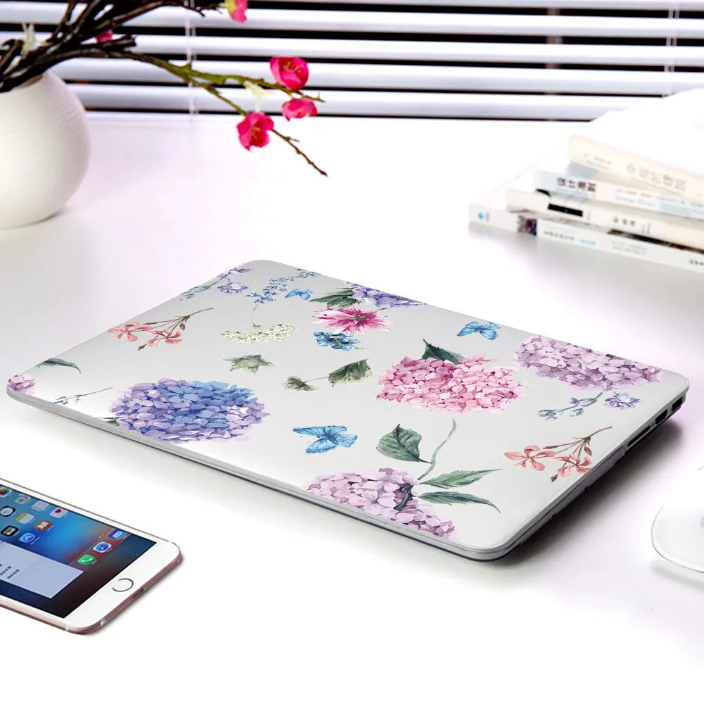 MacBook protective shell with floral pattern design covering laptop top and bottom surfaces