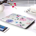 MacBook protective shell with floral pattern design covering laptop top and bottom surfaces