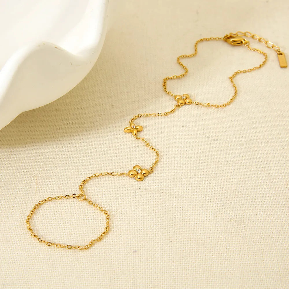 Women's stainless steel bracelet with geometric flower and eight-pointed star charms in gold colour