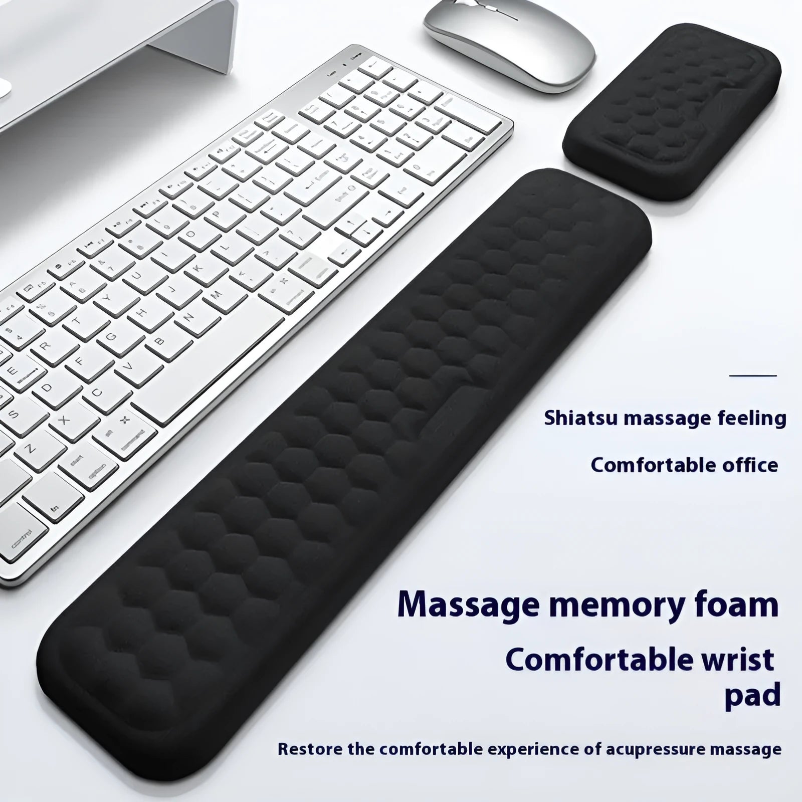 Grey and black memory foam mouse wrist rests with cloth or leather covers on a desk.