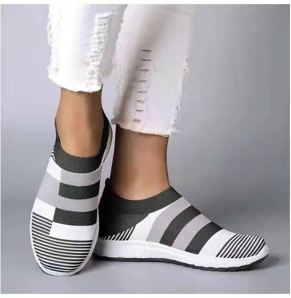 Women's knitted slip-on sneakers in grey with breathable mesh upper and flat foam sole
