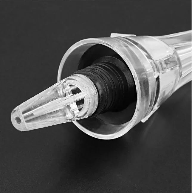Compact clear acrylic wine aerator with a stainless steel filter, measuring 16cm long.
