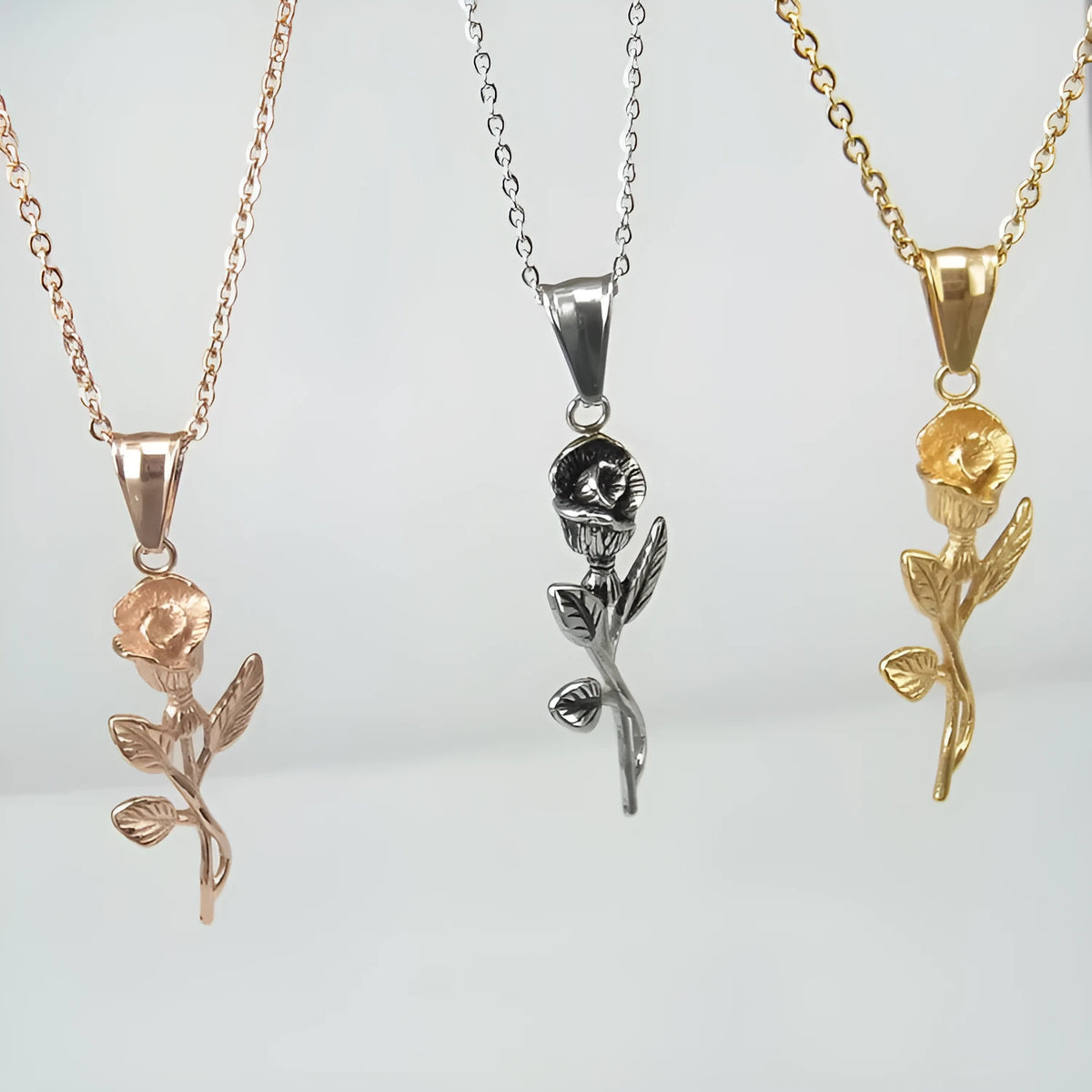 Stainless steel gold roses necklace for men with cross pendant and polished chain on display