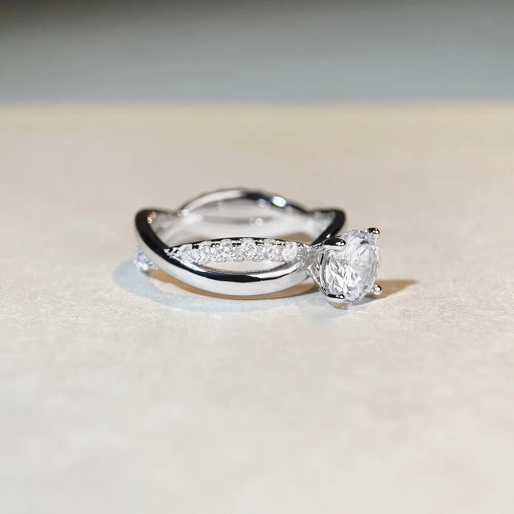 Geometric silver moissanite ring with a 1 karat stone and twisted band.