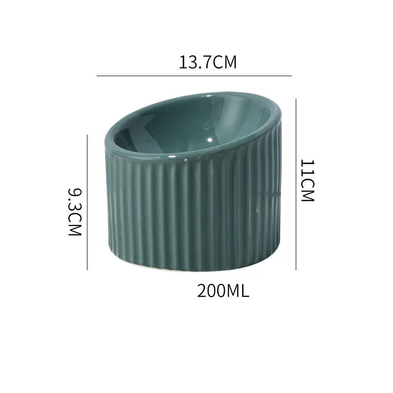 Elevated ceramic cat bowl in green colour showing raised design for feeding