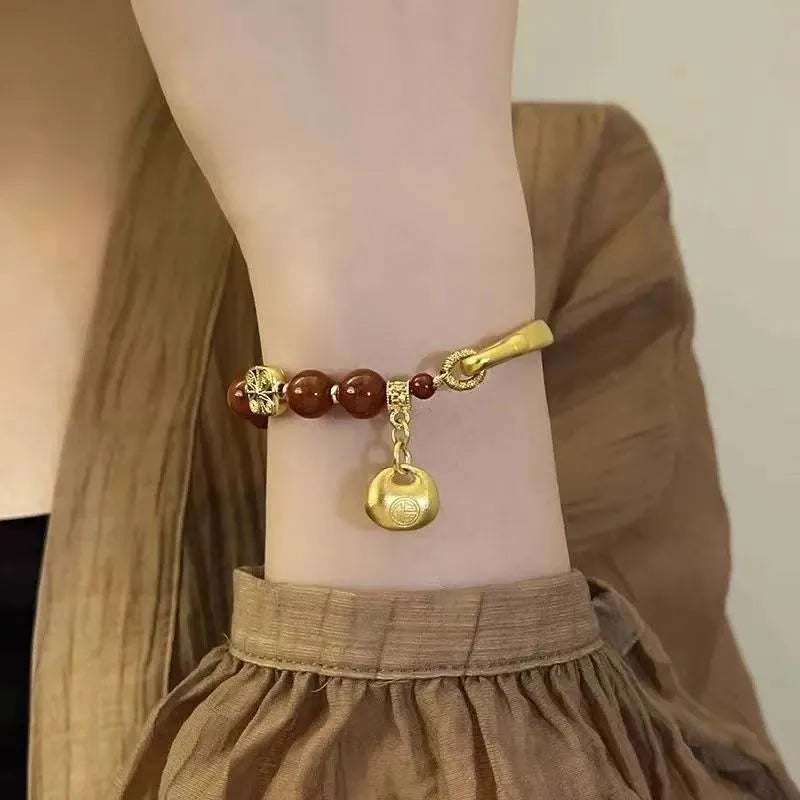 Golden South Red agate lucky bag bracelet with character ingot design for women