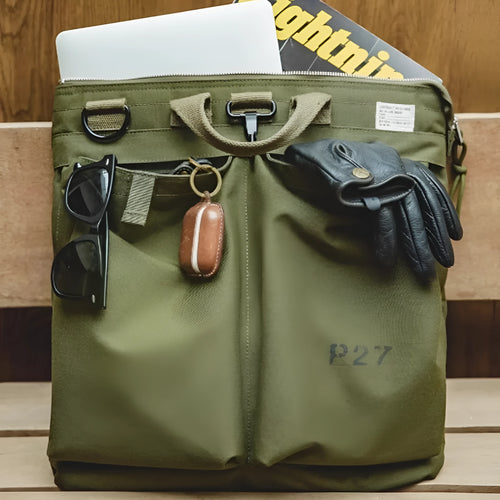 Retro canvas crossbody messenger bag in military green showing laptop compartment and phone storage