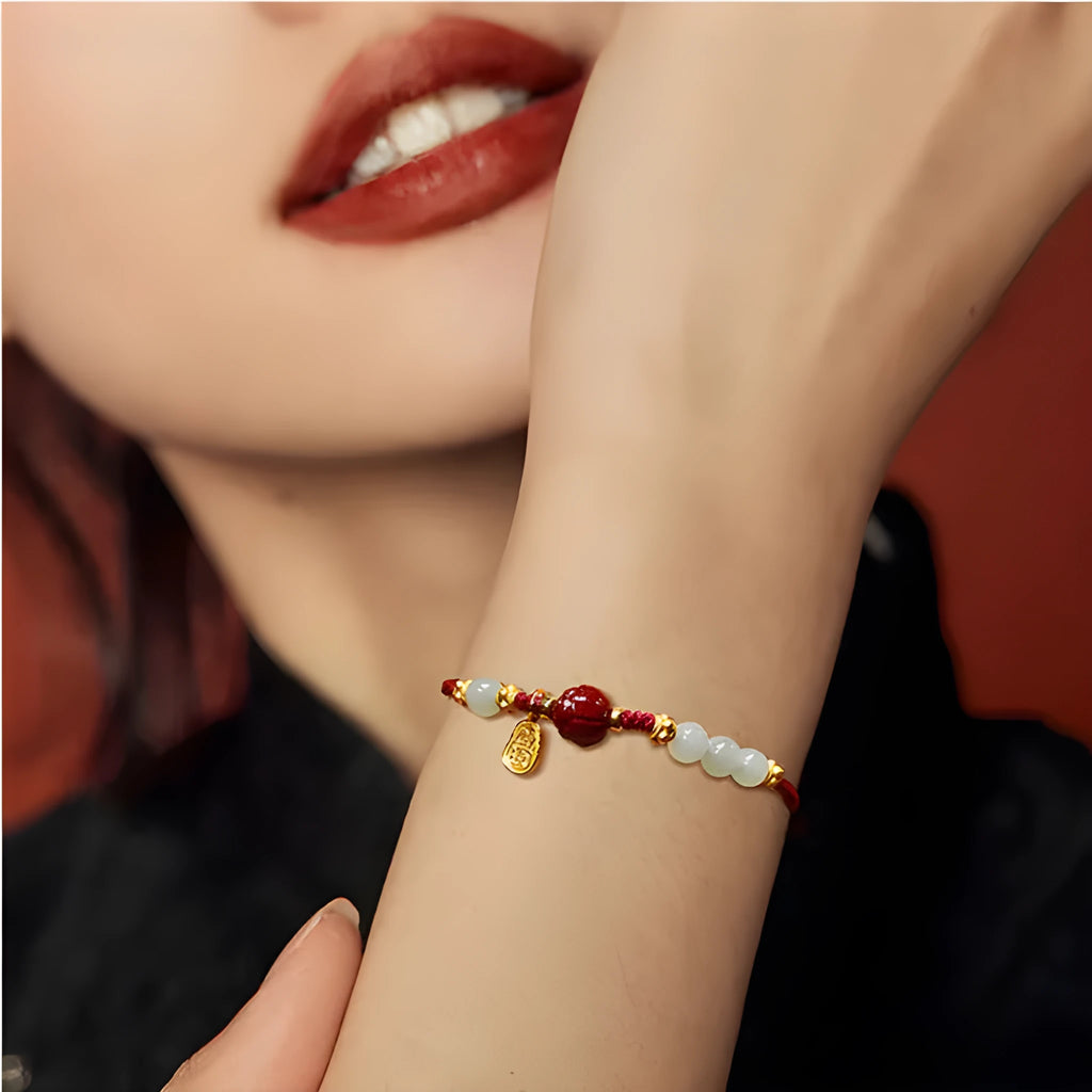 Handmade women's bracelet with cinnabar red rope, 925 silver, and Hetian jade on an adjustable chain.