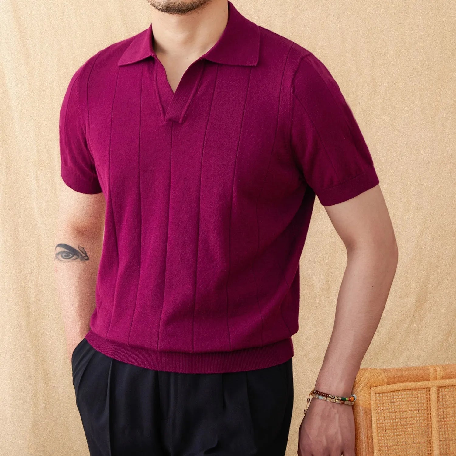 Men's purple short sleeve polo top with a knitted sunken stripe pattern and a classic collar.