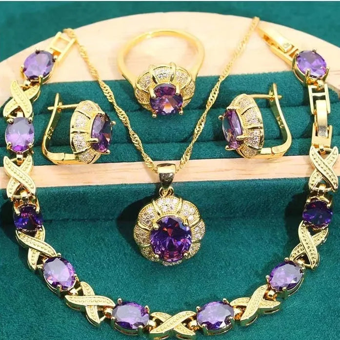 18k gold-plated necklace, bracelet, earrings, and ring set with blue cubic zirconia stones.