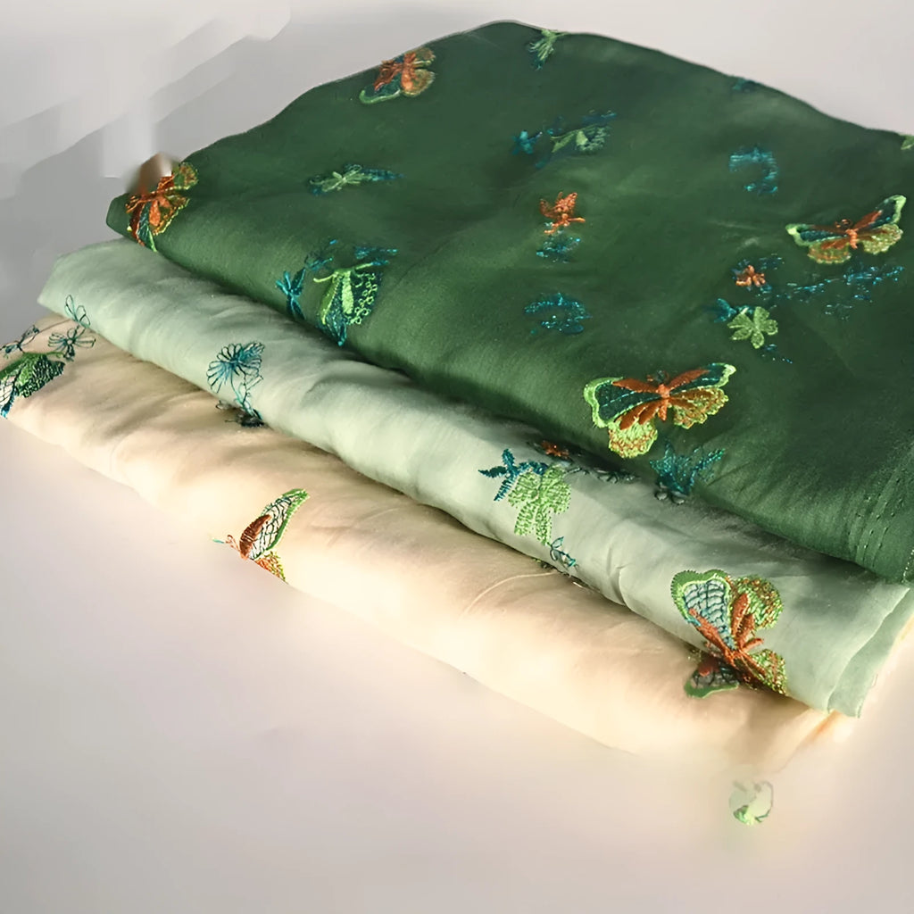 A piece of pure ramie fabric in beige, dark green and grass green, showing its texture and 140cm width.