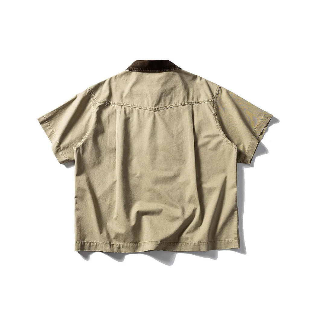 Grey loose-fit short-sleeved cardigan-style overalls shirt on a hanger.