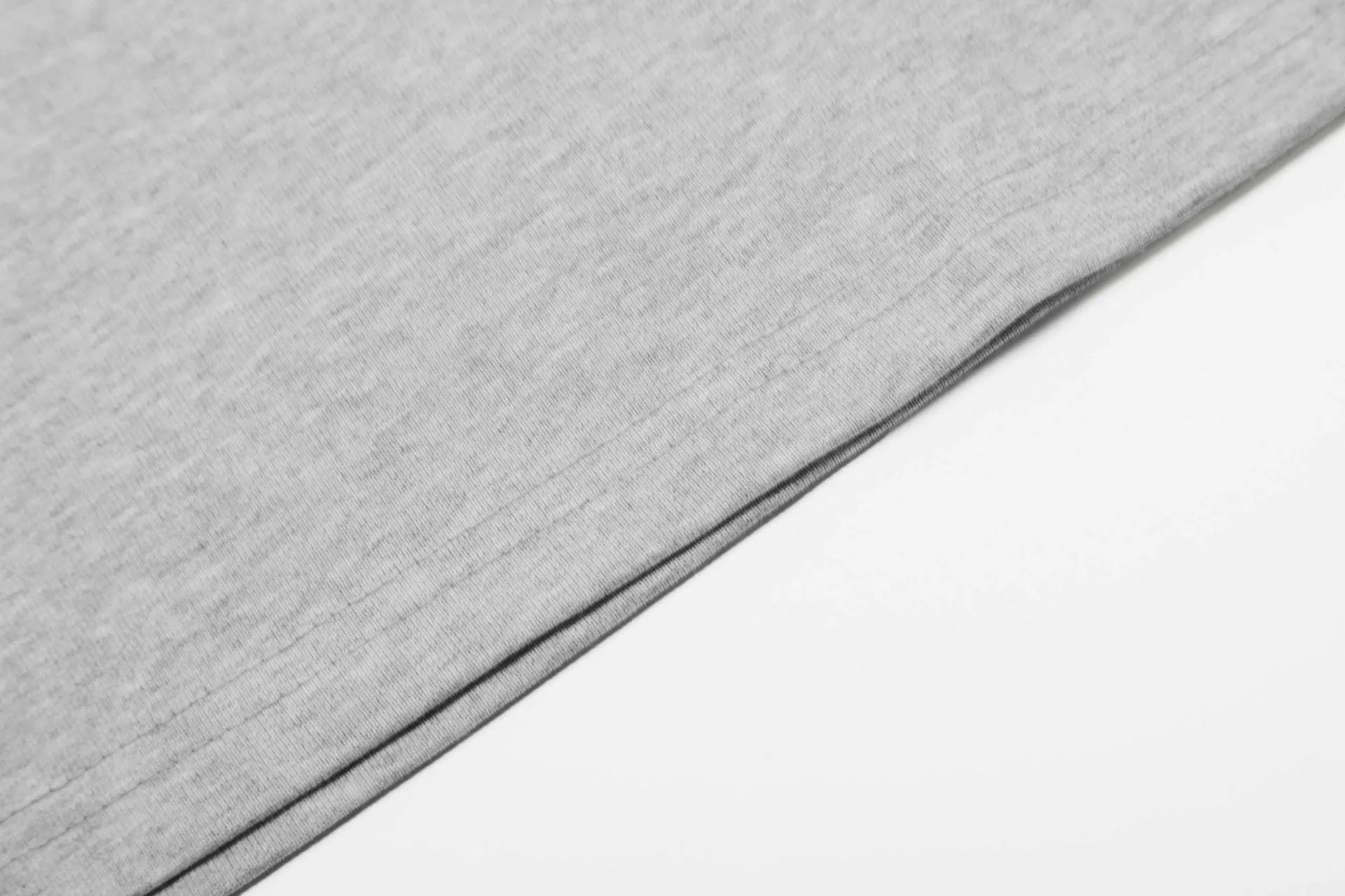 A man or woman wearing a loose grey cotton long sleeve retro pullover.
