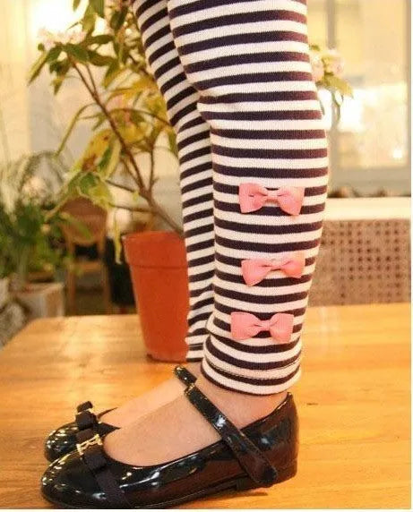 Pink cotton clothing set for girls on a hanger, showing short sleeves.