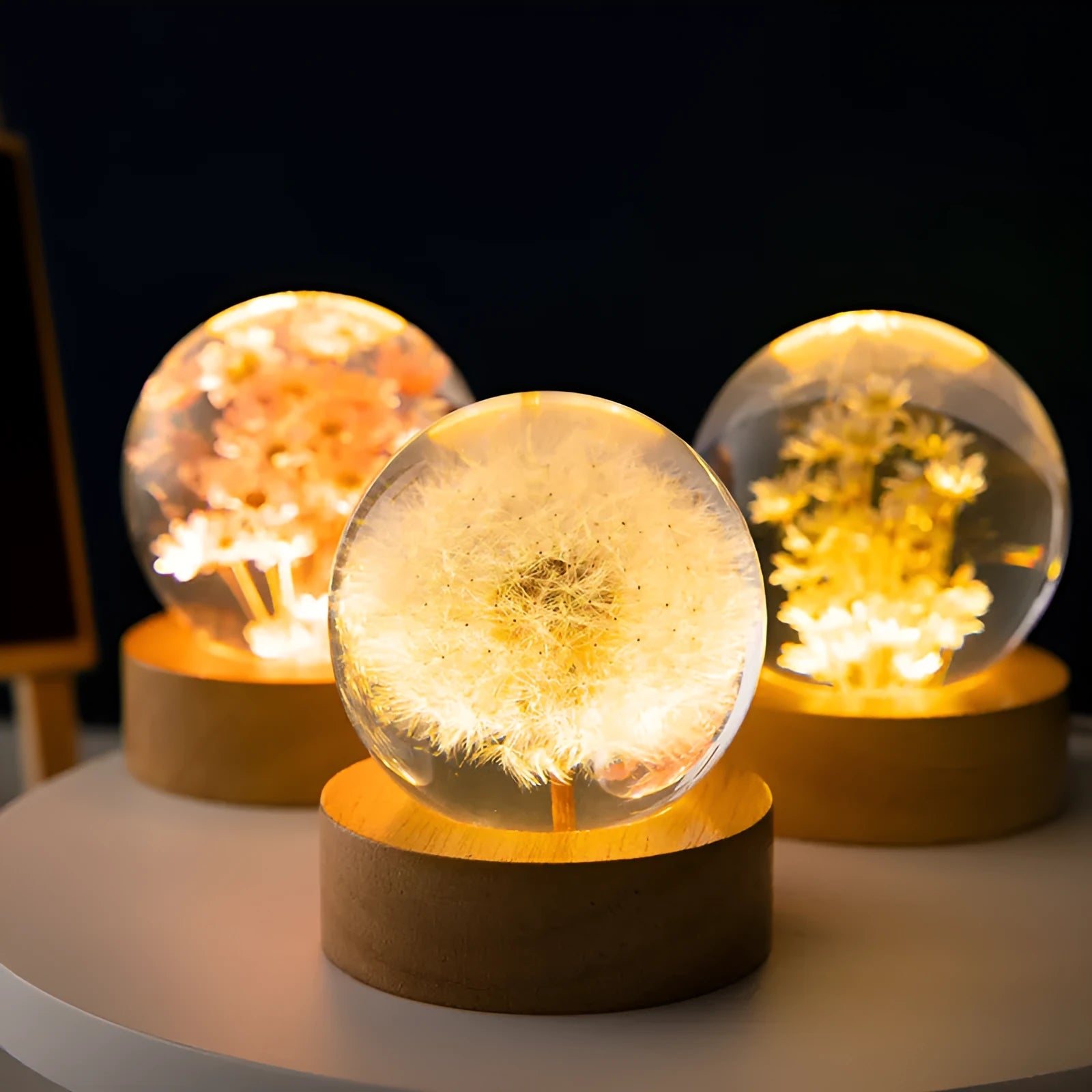USB-powered eternal flower night light with clear resin crystal ball on a natural beech wood base.