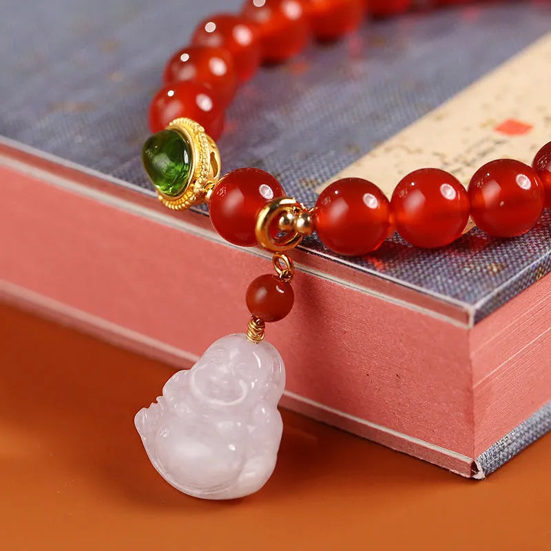 Red agate bracelet with ancient gold jade hanging element and Buddha pendant