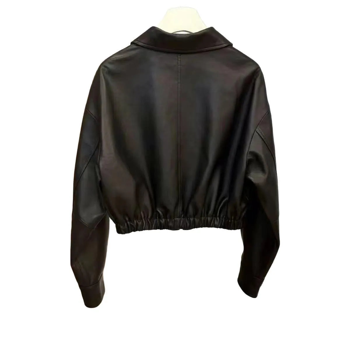 Women's black faux leather square-neck zip jacket with princess sleeves and washed finish on a model