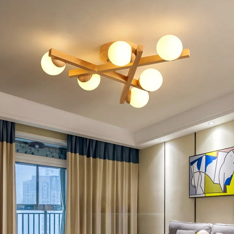 Scandinavian wooden-style ceiling light with three adjustable black lamp heads on angled arms