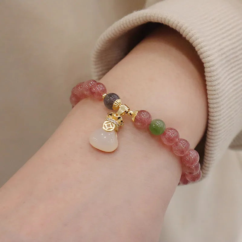 Strawberry quartz bracelet with geometric shapes, purse charm, and safety buckle closure