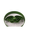 Grey plastic slow feeder pet bowl with windmill pattern and white non-slip silicone base on a kitchen floor.
