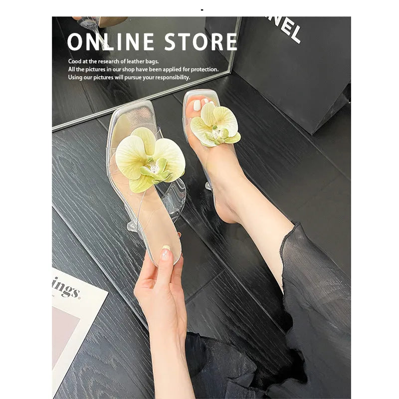 Matcha green women's high heel sandal with square toe and flower decoration on a plain background